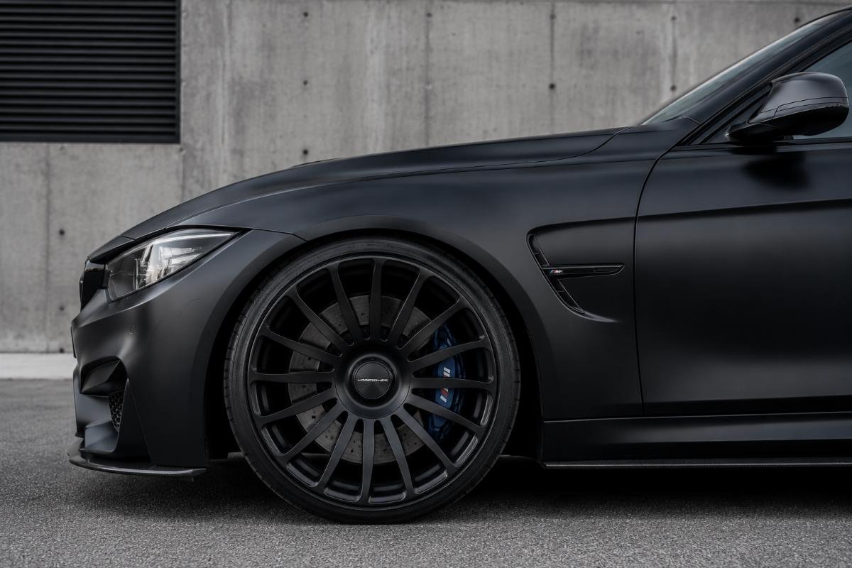 Side profile of a matte black 19-inch concave turbine design wheel fitted to a performance sedan
